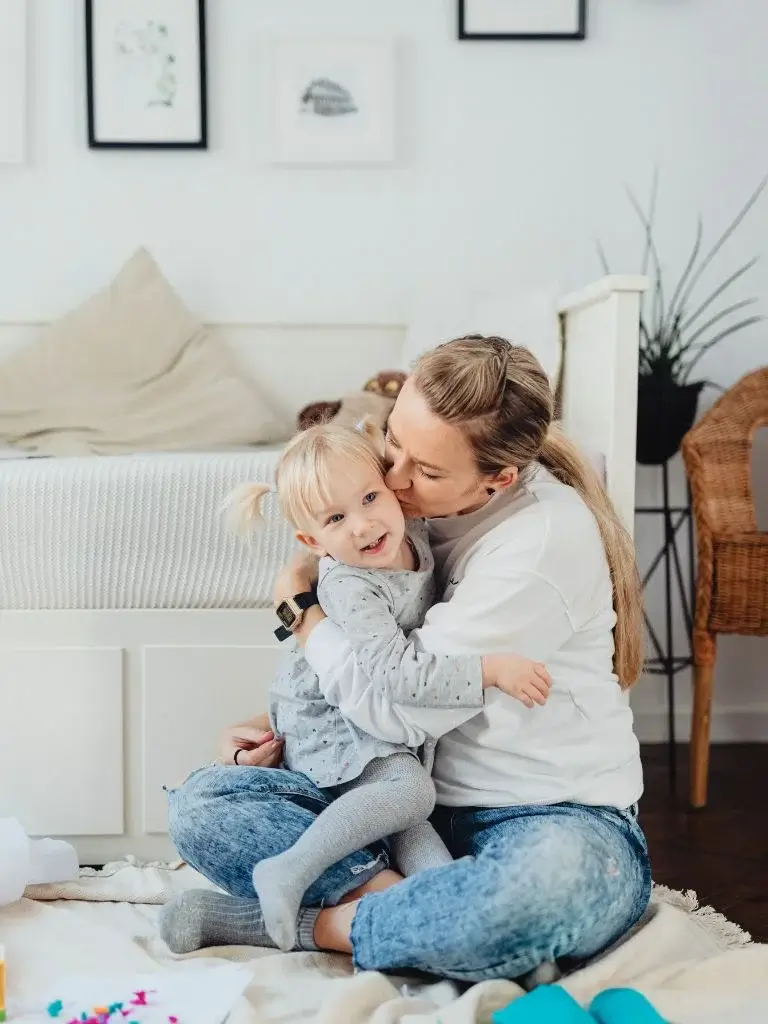 a mom hugging her daughter