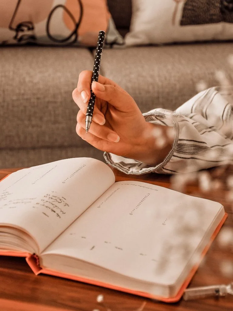 a shot of a hand and a journal