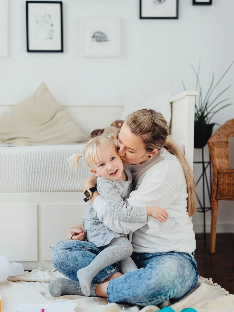 a shot of A mom caressing her daughter
