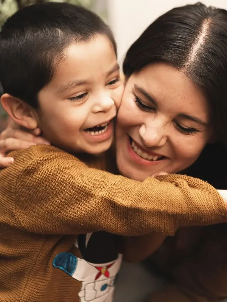 a mom hugging her toddler son