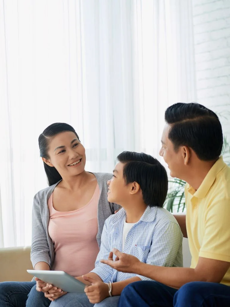 mom and dad talking to each other while the son watches them