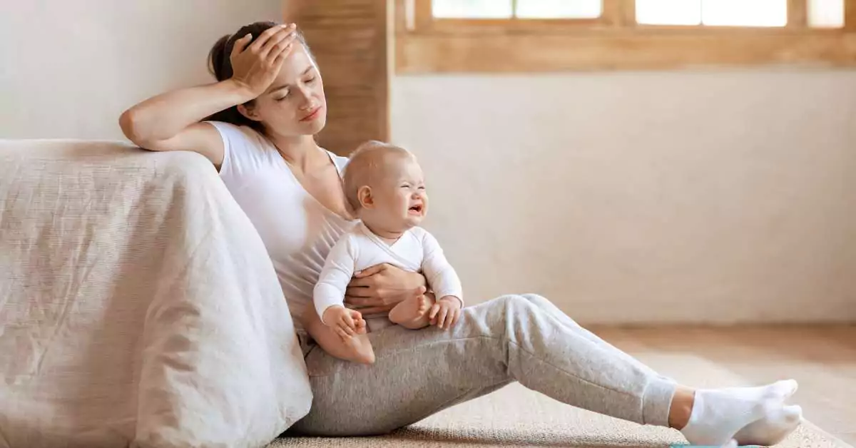 This image features a burnt out mom holding her child.