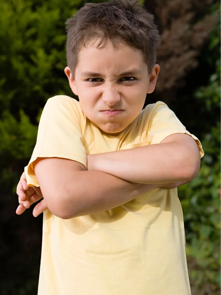 stubborn kid with a frowny face