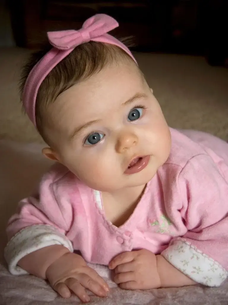 a baby laying on floor having tummy time