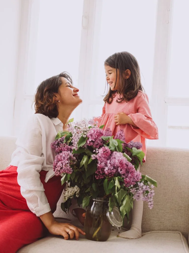 a mom and a daughter looking at each other lovingly