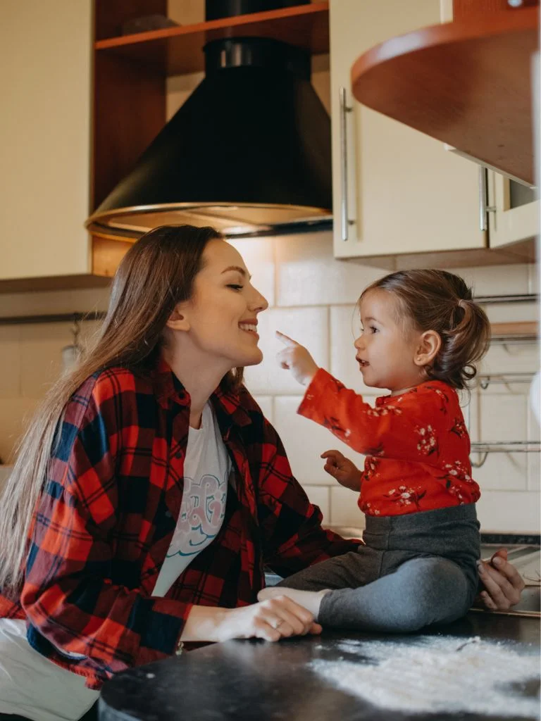 a mom and daughter playing together