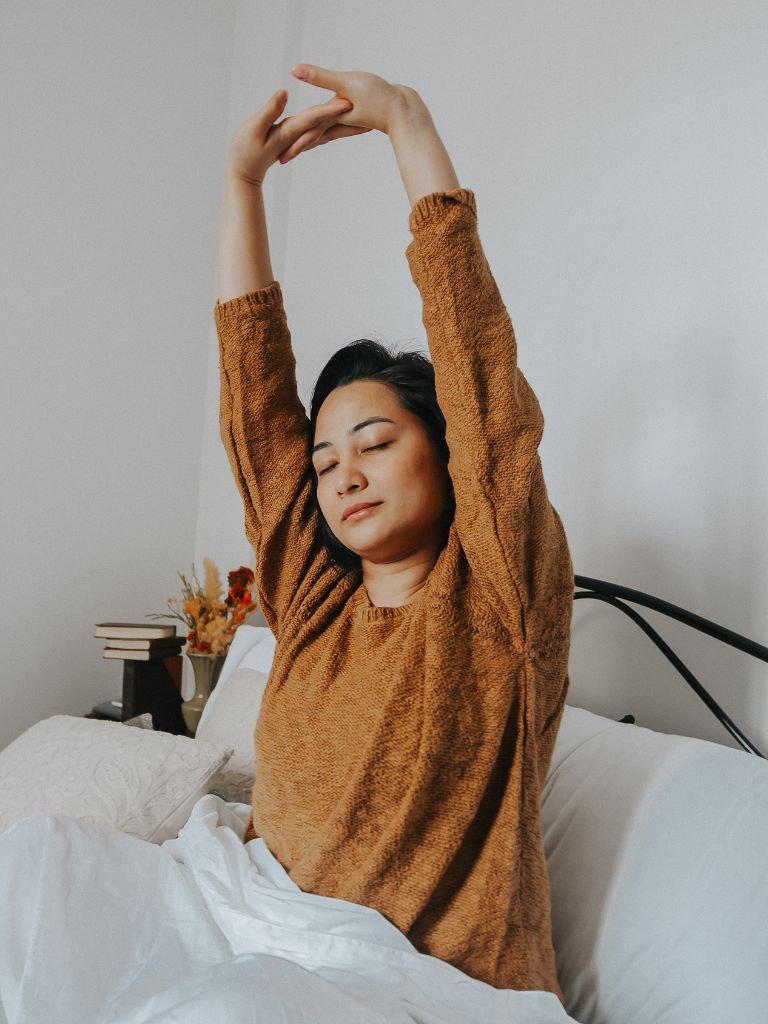 a mom stretching her body just after waking up